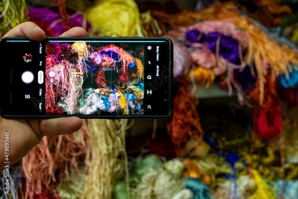 Obraz Photography of colored threads with mobile