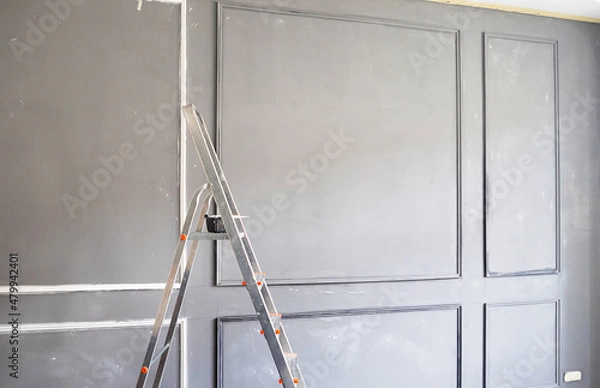 Fototapeta process of installation and painting of moldings for the interior in a classic minimalist style