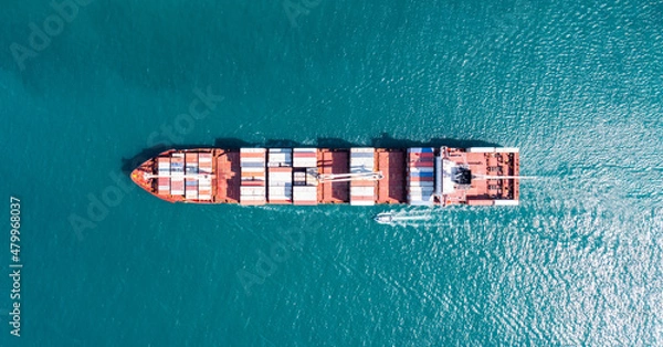 Fototapeta Aerial tip view of cargo ship carrying container and running for export  goods  from  cargo yard port to custom ocean concept technology transportation , customs clearance.