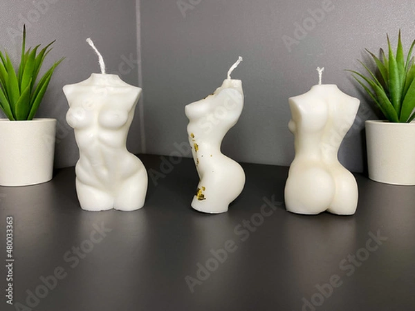 Fototapeta three trendy soy candle female bodies on the grey table