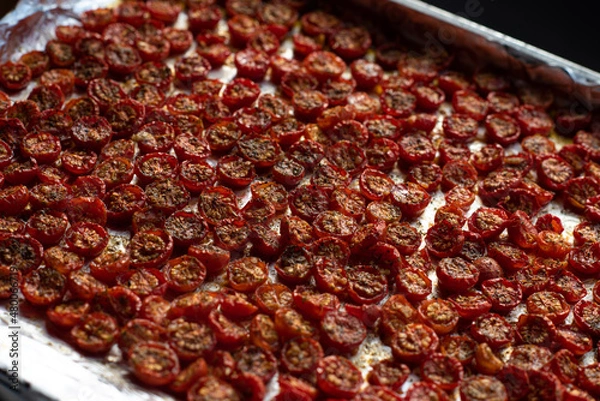 Fototapeta Sun dried tomatoes with fresh herbs and spices. Slate background. Step by step cooking