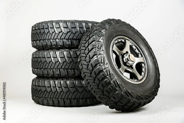 Fototapeta suv wheels are on a gray background.  set of mud wheels, studio shot. off-road tires close up