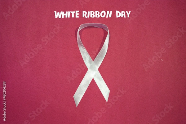 Fototapeta White Ribbon Day Symbol, isolated on red  background