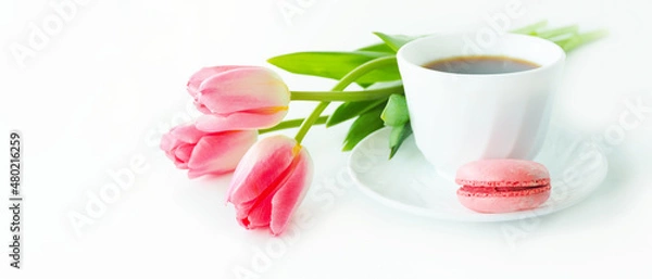 Obraz three pink tulips, macarons and a cup of coffee on a white table..