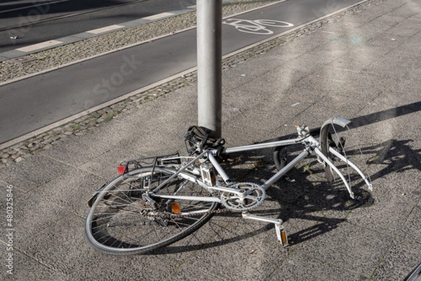 Fototapeta Bicycle tied to a street pole with stolen parts and missing front wheel, Prenzlauer Berg district in Berlin, Germany.