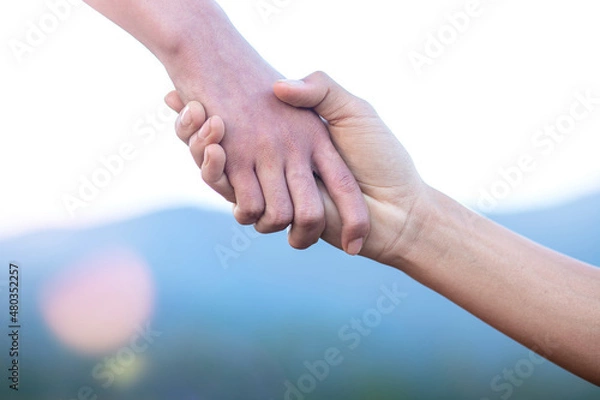 Fototapeta helping hand with mountain background