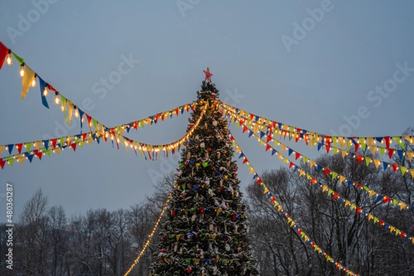 Obraz Christmas tree, colored flags and lights