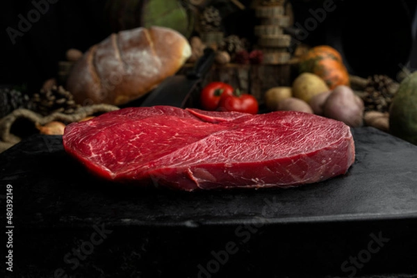 Fototapeta Raw beef steak in the rustic kitchen