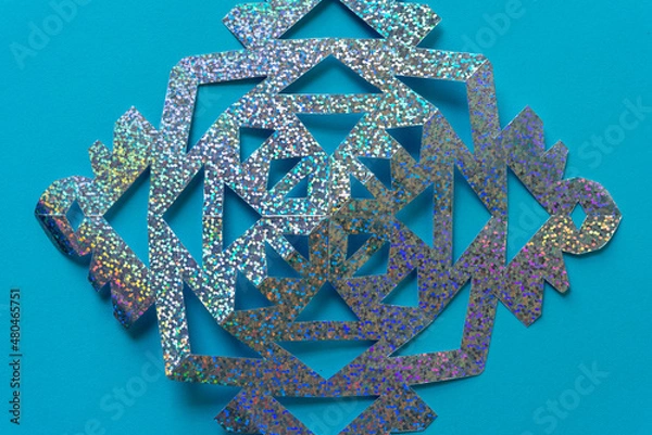 Obraz cut glitter paper shape on blue
