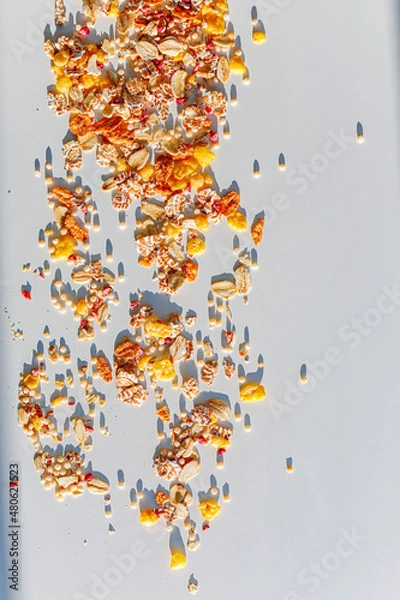 Fototapeta Different sorts of breakfast cereal products. Set with different cereal grains on white background, top view. Sunny breakfast concept.