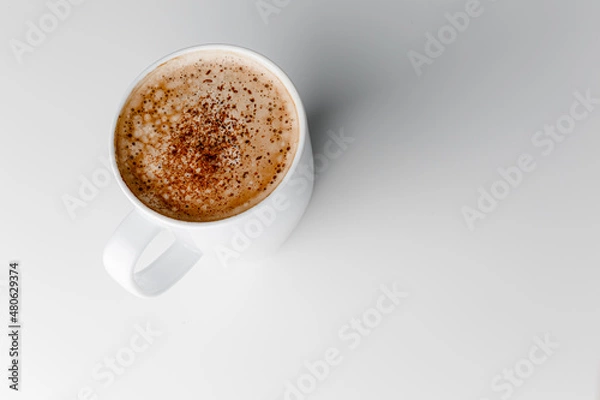 Fototapeta Hot coffee cappuccino in ceramic cup isolated on white background, clipping path included. cappuccino with spices and cinnamon. Cozy morning concept. Hygge.
