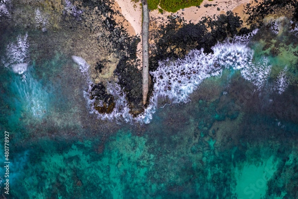 Fototapeta Aerial view of a fishing pier and the waves crashing on the south coast of Mauritius island
