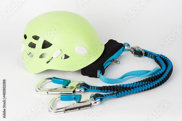 Fototapeta Via ferrata set, one touch carabiners, elastic safety branches with strap fall absorber and green climbing helmet