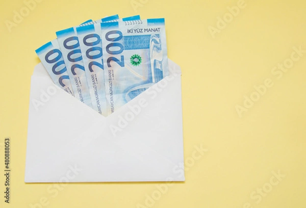 Obraz An envelope with money isolated on the yellow background