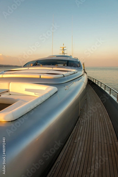 Fototapeta Beautiful sea view from the starboard side of a luxury yacht at sunset / sunrise - vertical orientation
