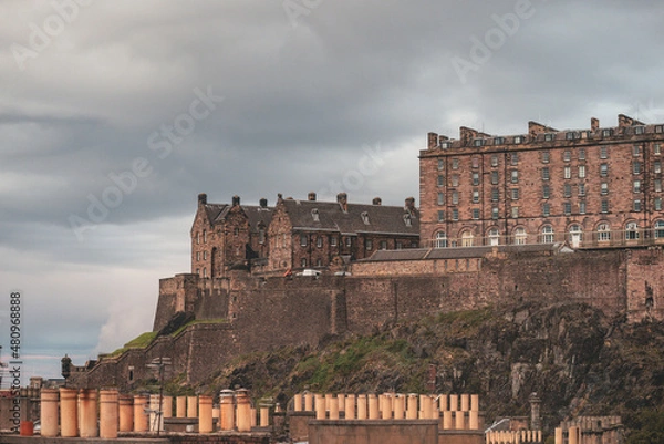 Fototapeta Stunning aerial view of Edinburgh in Scotland, with the castle dominates the skyline, casting its shadow over the surrounding historic town occupying commanding position on volcanic crag with cliffs