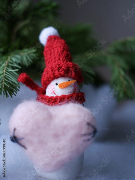 Obraz snowman with heart on white background