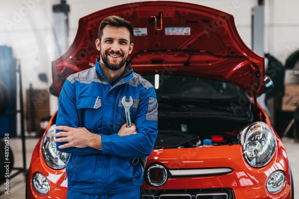 Fototapeta A professional mechanic working in a car service.