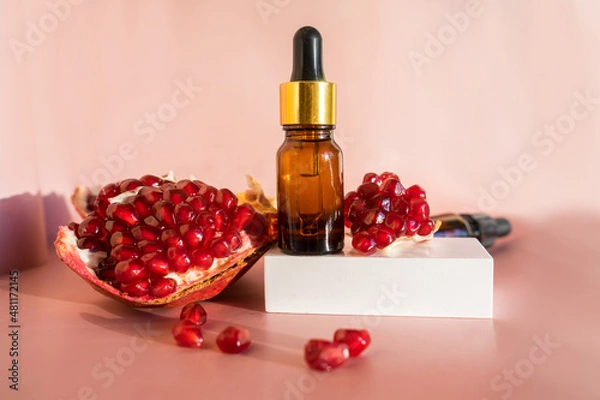 Obraz Composition with natural cosmetic oil and pomegranate on light background