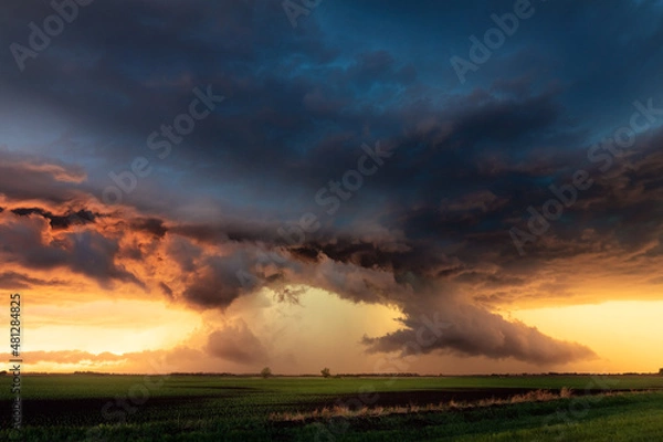 Obraz Sunset storm clouds and dramatic sky over a field