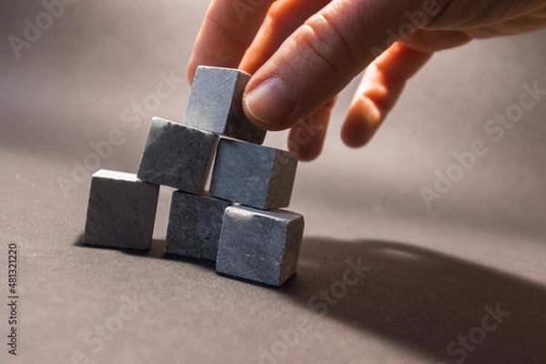 Obraz Whiskey stones stand on a gray background. Stones for cooling drinks. High quality photo