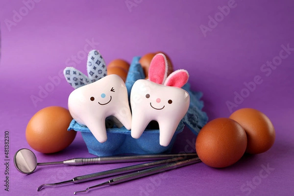 Fototapeta easter bunny and eggs.Happy easter.Stomatology concept.eggs, dentist tools and teeth figurines