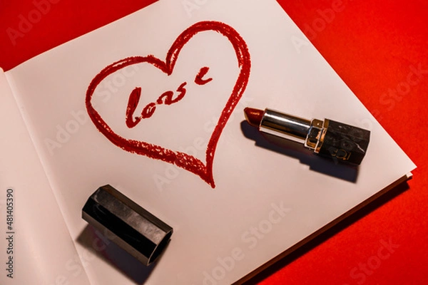 Obraz Heart painted with red lipstick on a white sheet on a red background. High quality photo