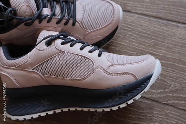 Obraz Women's sneakers are pink with gray trim.