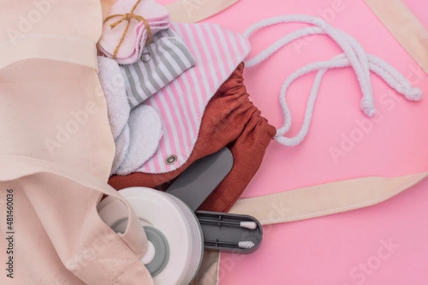 Fototapeta Silicone ear sticks, collapsible silicone mug, Reusable Menstrual Pad, reusable cotton pads, mesh bag for shopping. Zero waste concept. Picture with copy space