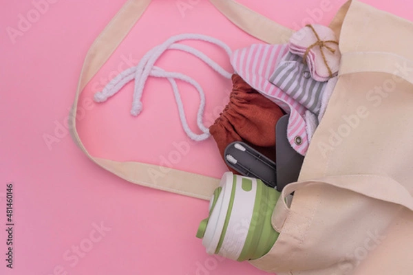 Fototapeta Silicone ear sticks, collapsible silicone mug, Reusable Menstrual Pad, reusable cotton pads, mesh bag for shopping. Zero waste concept. Picture with copy space