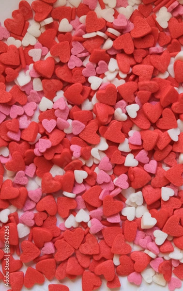 Fototapeta sprinkle hearts on a white background with a place for text
