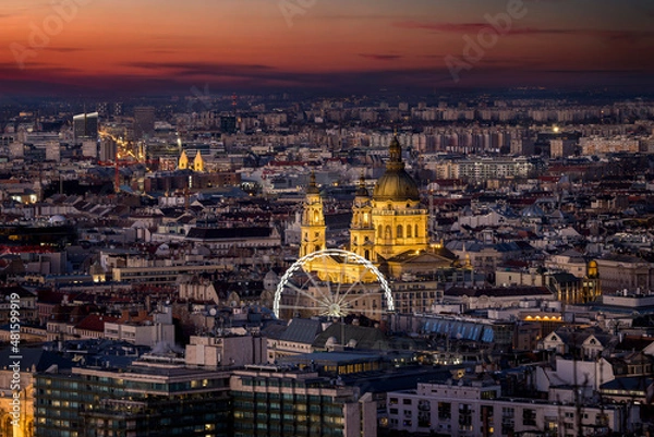 Fototapeta Elevated view of the illuminated urban skyline of Budapest, Hungary, with the famous St. Stephen's Basilica during dusk