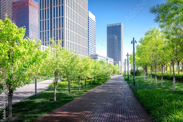 Obraz Cityscape intelligent building ,hold smart phone for build and make your green city.