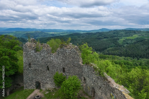 Fototapeta The ruins of an ancient castle on the Andelska mountain in Karlovy Vary (Czech Republic) on a sunny summer day. Medieval stone polygonal masonry walls. Panoramic view of scenic mountainous area 