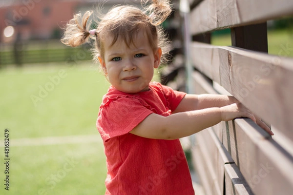 Obraz Serious little child on the street looking straight into the frame.