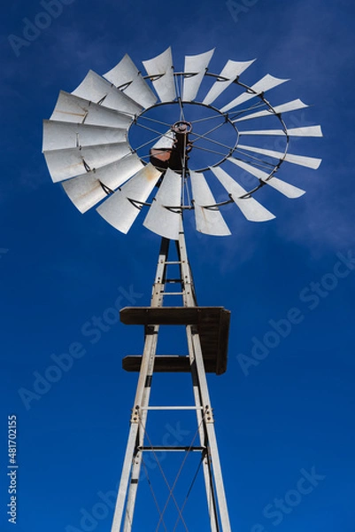 Fototapeta Windmill in front of a blue sky