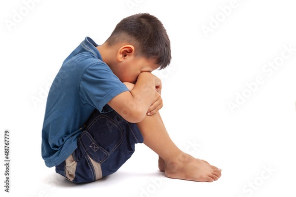 Obraz  sad boy sittign on white background
