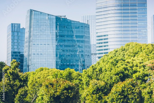 Obraz The concept of modern urban architecture, urban green plants and green office