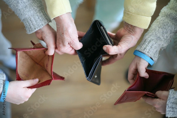 Fototapeta Three people holding an empty wallet in their hands