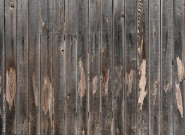 Fototapeta old boards from fences and gates are covered with dirt and old paint