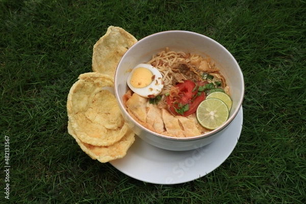Fototapeta A bowl of Soto or Soup. Soto is a traditional soup consisting mainly of broth, meat and vegetables.
