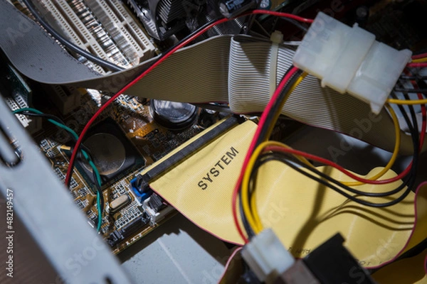 Obraz Old computer inside. Printed circuit boards, wires, connectors, microchips inside the system unit.