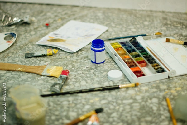 Fototapeta Blue can with gouache and other paint and brush on the table