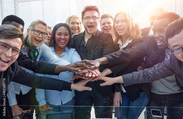 Obraz Business team stacking their hands together