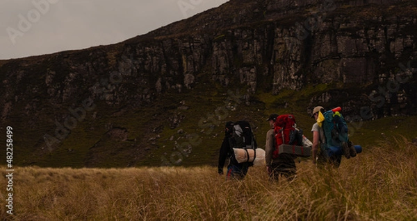 Fototapeta Men Walking in a Mountain Landscape