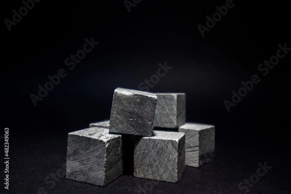 Fototapeta Whiskey cubes lie on a dark background. Stones for cooling drinks.