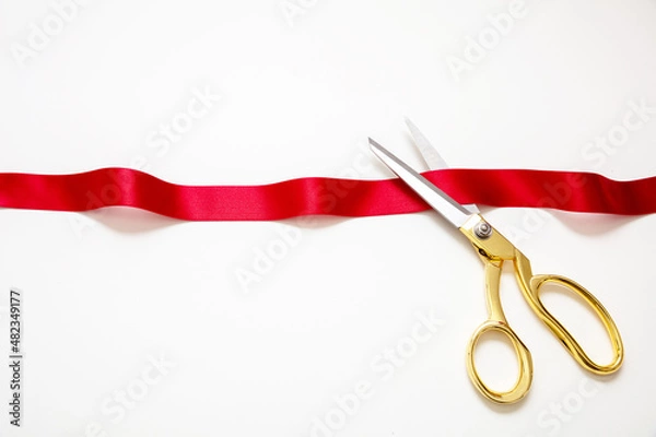 Obraz Grand opening, ribbon cut, overhead of gold scissors and red satin satin isolated on white