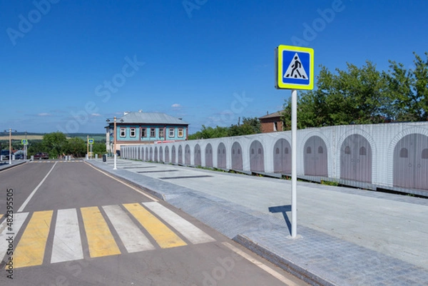 Obraz Zebra crossing across the road with a small-shaped sign in the city of Zaraysk on a summer day