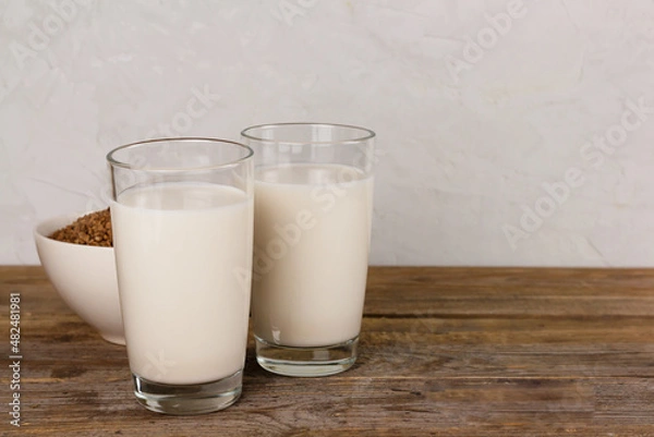 Fototapeta Two glasses with alternative dairy free buckweat milk. Lactose free beverage