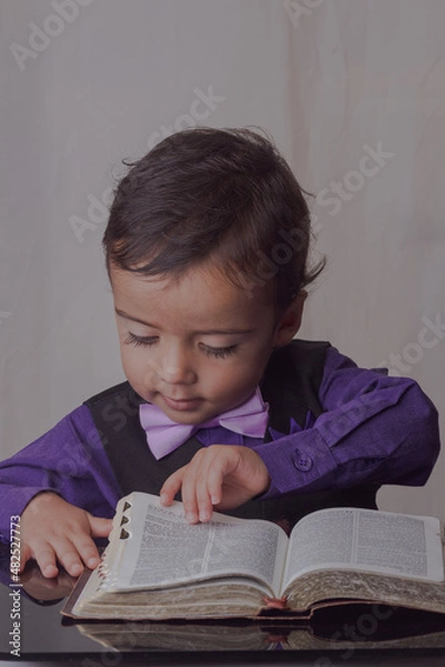 Fototapeta portrait of little man reading the word of God